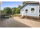 A spacious deck features an outdoor seating area and steps to the backyard at 6942 Cottonwood Trl, Riverdale, GA 30296