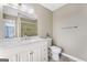 Bathroom features a white vanity with marble countertop and glass shower at 6942 Cottonwood Trl, Riverdale, GA 30296