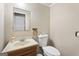 A simple powder room features a toilet, cabinet sink, and towel rack at 6942 Cottonwood Trl, Riverdale, GA 30296