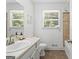 Well-lit bathroom featuring a single sink vanity, and shower-tub with a tile surround at 6942 Cottonwood Trl, Riverdale, GA 30296