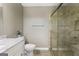 This bathroom has a white vanity, marble countertop, and walk-in shower at 6942 Cottonwood Trl, Riverdale, GA 30296