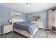 Spacious primary bedroom features a neutral color palette, and wood-look flooring at 6942 Cottonwood Trl, Riverdale, GA 30296