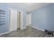 This bedroom features light wood flooring, white trim, and a closet at 6942 Cottonwood Trl, Riverdale, GA 30296