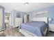 Primary bedroom features a neutral color palette, wood-look flooring, and ensuite bath at 6942 Cottonwood Trl, Riverdale, GA 30296