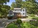 Charming two-story home with a wooden porch and a well-maintained front yard at 6942 Cottonwood Trl, Riverdale, GA 30296