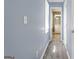 Hallway with wood-look flooring, a window, and access to a bathroom at 6942 Cottonwood Trl, Riverdale, GA 30296