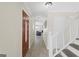Open hallway features wood-look tile and a staircase, leading to the living room with a fireplace at 6942 Cottonwood Trl, Riverdale, GA 30296