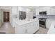 Bright kitchen featuring stainless appliances, a center island, and stylish white cabinetry at 6942 Cottonwood Trl, Riverdale, GA 30296