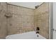Clean, tiled shower/tub combination with neutral tiles and updated fixtures for a relaxing experience at 6942 Cottonwood Trl, Riverdale, GA 30296