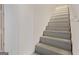 Stairway features neutral paint, neutral steps and wood trim at 6942 Cottonwood Trl, Riverdale, GA 30296