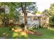 A lovely backyard view of home showcasing an outdoor deck and a verdant lawn at 17 Hampton Way, Carrollton, GA 30116