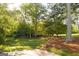 Expansive backyard with mature trees, lush green grass, and a sense of privacy at 17 Hampton Way, Carrollton, GA 30116