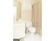 Bright bathroom with a white vanity, toilet and shower with neutral shower curtain at 17 Hampton Way, Carrollton, GA 30116