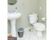 Neutral bathroom featuring a pedestal sink, toilet, and tiled floors at 17 Hampton Way, Carrollton, GA 30116