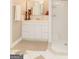 Well-lit bathroom with a white vanity, drawers and decorative items plus a shower at 17 Hampton Way, Carrollton, GA 30116