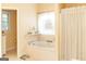 Bathtub view from bathroom with white tiled floors, bathtub in an alcove, with a separate adjacent toilet at 17 Hampton Way, Carrollton, GA 30116