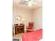 Bedroom featuring wood floors, an antique mirror, a lamp, and a rocking chair at 17 Hampton Way, Carrollton, GA 30116