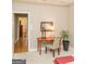 Bedroom featuring a desk with a decorative mirror and plant, leading to hallway at 17 Hampton Way, Carrollton, GA 30116