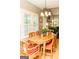 Sunlit breakfast nook with a round wooden table, shutters, and views of the backyard at 17 Hampton Way, Carrollton, GA 30116