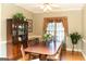 Traditional dining room with hardwood floors, a ceiling fan, elegant window treatment, and classic furniture at 17 Hampton Way, Carrollton, GA 30116