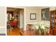 Dining room that transitions into living room featuring hardwood floors, dining table, and decorations at 17 Hampton Way, Carrollton, GA 30116