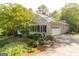 Side view of a brick home with a two-car garage, well-maintained landscaping, and a circular driveway at 17 Hampton Way, Carrollton, GA 30116