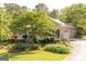 Beautiful exterior of the home showcasing brick facade, black shutters, attached garage and verdant landscaping at 17 Hampton Way, Carrollton, GA 30116