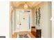 Inviting foyer featuring a decorative front door with sidelights, hardwood floors, and a bench at 17 Hampton Way, Carrollton, GA 30116