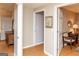 Open hallway showcases wood look vinyl flooring, framed art and neutral colors at 17 Hampton Way, Carrollton, GA 30116
