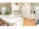 Well-lit kitchen with a sink and countertops, complemented by stylish laminate flooring at 17 Hampton Way, Carrollton, GA 30116
