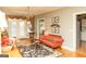 Cozy living room with hardwood floors, a decorative rug, elegant curtains, and a view of the backyard at 17 Hampton Way, Carrollton, GA 30116