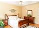 Bedroom featuring a king bed, wood floors, ceiling fan and bright natural light with warm tones at 17 Hampton Way, Carrollton, GA 30116