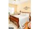 Bedroom featuring a king bed, wood floors, ceiling fan and bright natural light with warm tones at 17 Hampton Way, Carrollton, GA 30116