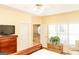 Bedroom featuring a TV, natural light, ceiling fan, and adjoining en suite bathroom at 17 Hampton Way, Carrollton, GA 30116