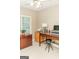 Office area with light tan walls, bright natural light, and dark desk space for computer and sewing machine at 17 Hampton Way, Carrollton, GA 30116