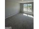 A bedroom showcasing neutral walls, a window offering natural light, and plush carpeting for a cozy atmosphere at 1151 Park Center Nw Cir, Austell, GA 30168