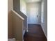 Inviting entryway features wood-look floors, a paneled front door, and staircase access at 1151 Park Center Nw Cir, Austell, GA 30168