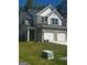 Charming two-story home boasts brick accents, gray shutters, a well-manicured lawn, and a two-car garage at 1151 Park Center Nw Cir, Austell, GA 30168