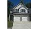 Charming new construction with brick accents, gray shutters, a well-manicured lawn, and a two-car garage at 1151 Park Center Nw Cir, Austell, GA 30168
