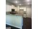 Well-lit kitchen with granite countertops, white cabinets, and modern appliances at 1151 Park Center Nw Cir, Austell, GA 30168