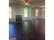 Spacious living room with hardwood floors, a fireplace, and natural light from large windows at 1151 Park Center Nw Cir, Austell, GA 30168