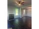 Open-concept living area featuring a fireplace, dark floors, and ample natural light at 1151 Park Center Nw Cir, Austell, GA 30168