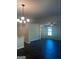 Bright living room with dark floors, ceiling fan, and modern light fixture at 1151 Park Center Nw Cir, Austell, GA 30168