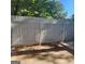 Backyard with a gray privacy fence, patio area, and mature trees in the background at 3818 Mulkey Sw Cir, Marietta, GA 30008