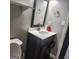 Bathroom vanity with a white countertop, dark wood cabinet, mirror, and open storage at 3818 Mulkey Sw Cir, Marietta, GA 30008