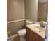 Bathroom with a wooden vanity, white countertop, toilet, and tiled floors at 3818 Mulkey Sw Cir, Marietta, GA 30008