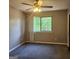 Bedroom featuring neutral walls, a window with a view, carpeted floor, and ceiling fan at 3818 Mulkey Sw Cir, Marietta, GA 30008