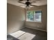 Neutral-toned bedroom with a ceiling fan, a window offering natural light, and plush carpeting at 3818 Mulkey Sw Cir, Marietta, GA 30008