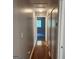 Hallway featuring vinyl floors, closet storage, and a view into an adjacent carpeted bedroom at 3818 Mulkey Sw Cir, Marietta, GA 30008