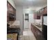 Kitchen boasts wood cabinets, granite countertops, and black appliances with a washer/dryer closet at 3818 Mulkey Sw Cir, Marietta, GA 30008